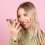 pretty-european-woman-casual-sweater-pink-wall